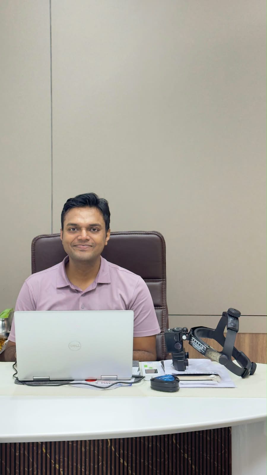 Dr. Vishvesh Agarwal seated at his desk
