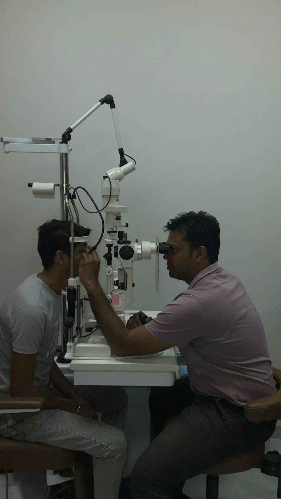 Dr. Vishvesh Agarwal examining a patient with a slit lamp